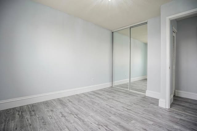Basement bedroom renovation with mirrored closets, Brampton