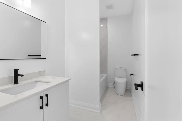 Bathroom renovation with modern vanity and black hardware, Mississauga