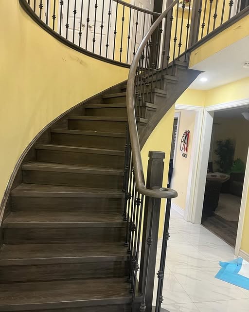 Curved oak staircase renovation with wrought iron spindles, Brampton GTA